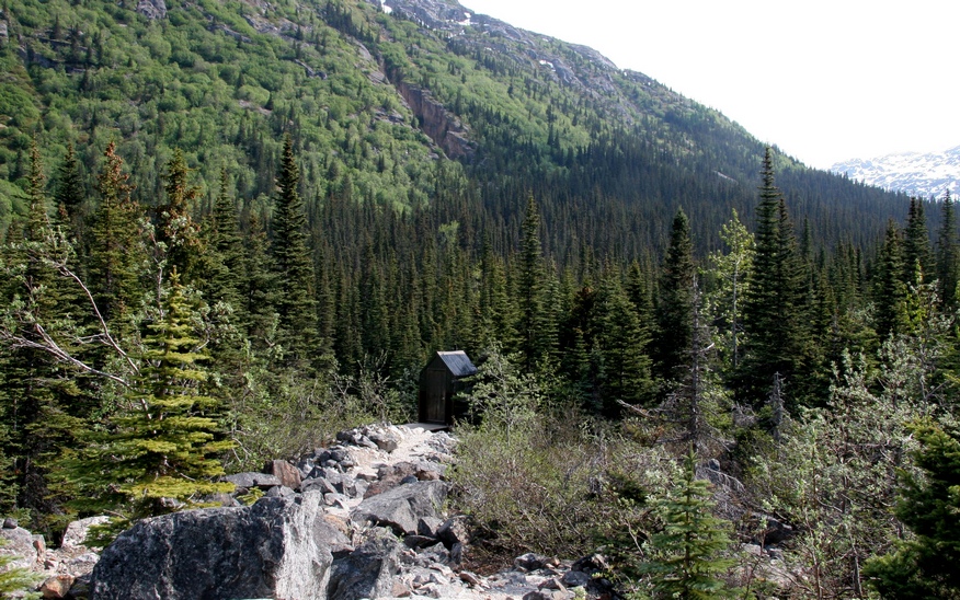 Description: The outhouse and surrounding mountains 